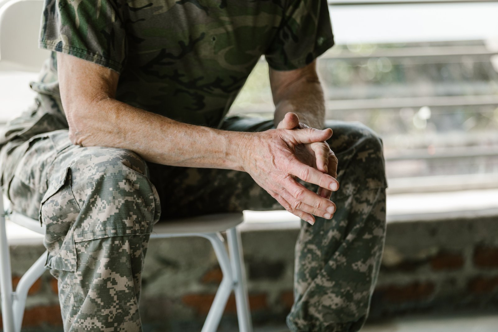Veteran in uniform seated indoors